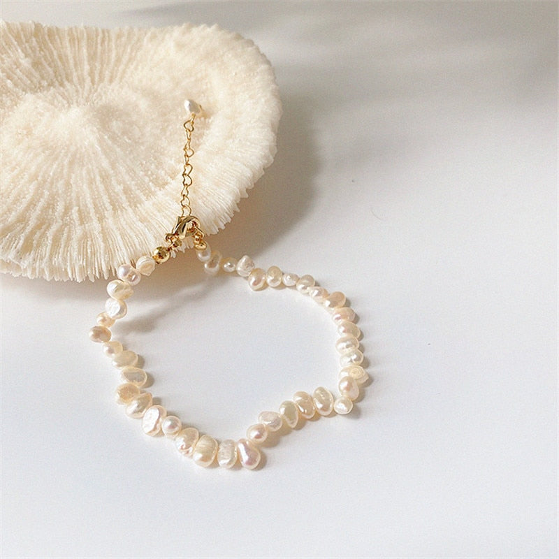 These vintage style natural freshwater pearl necklaces and bracelets are always a sweet fashion option. They have a retro beach feel and compliment all skin tones. The necklace sits at the clavicle.  Treat yourself of send someone a lovely, kind gift.