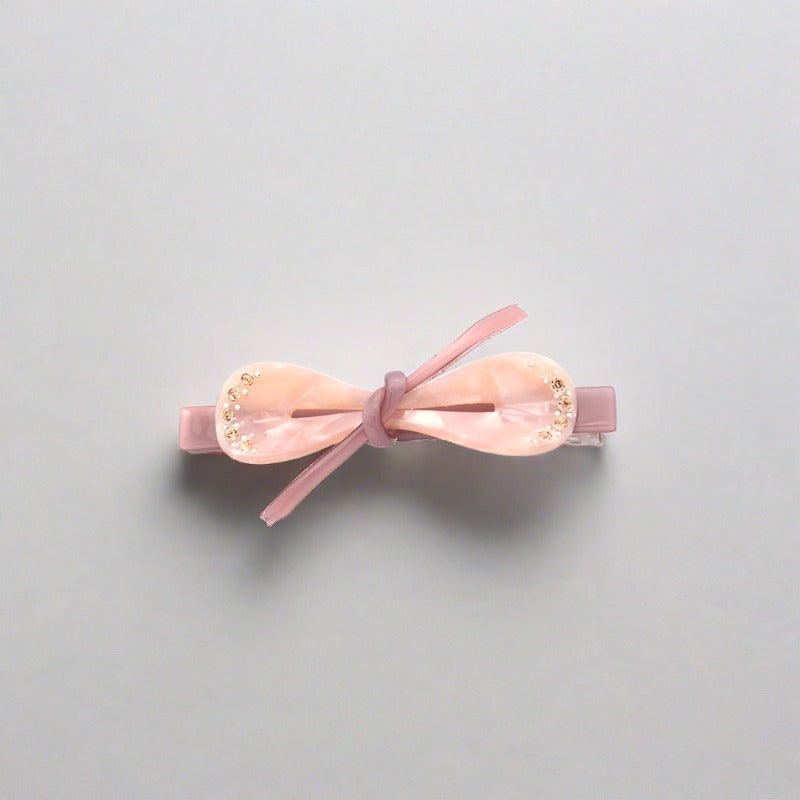 Bow shaped hair clip for women and girls available in a range of pretty and subtle, stylish colours.  Each clasp secures easily to all hair types - short and long, fine and thick.  These clips can also be used on clothing, shoes and bags to add a point of distinction and a fashionable emphasis.   Made from quality acrylic acetate which is an eco-friendly recyclable plastic material.